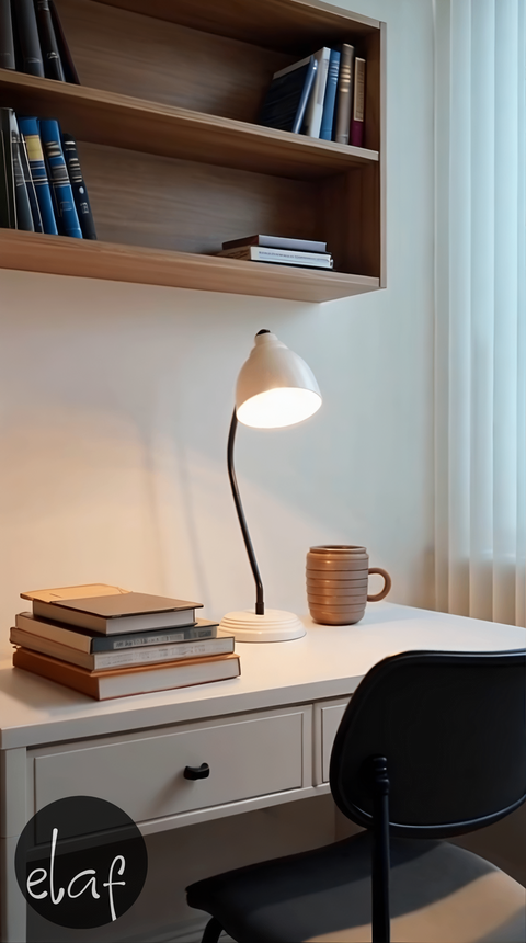 Vintage ivory desk lamp with curved black arm and adjustable metal shade on round base, ideal for home or office use