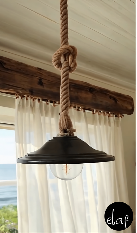 Rustic hanging pendant light with knotted natural rope and black metal shade, vintage bulb hanging from twisted cord