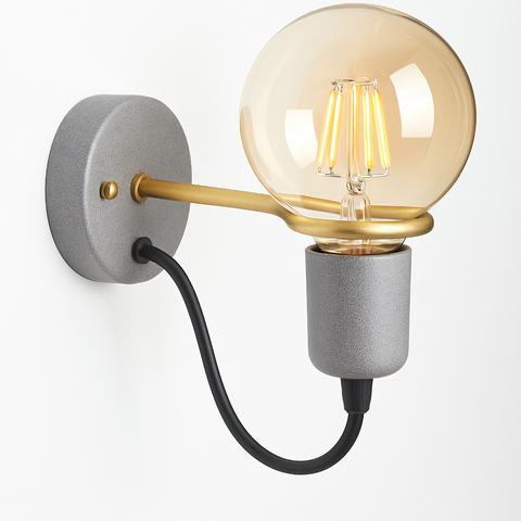 gray and gold wall sconce with exposed globe bulb and black cord, mounted on neutral wall near stacked books