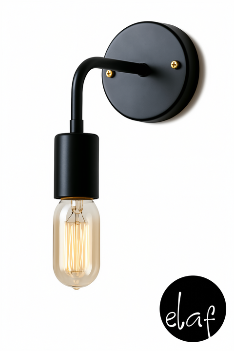 A black wall-mounted light fixture with a vintage bulb and gold accessories, designed in a modern style with a curved leg.