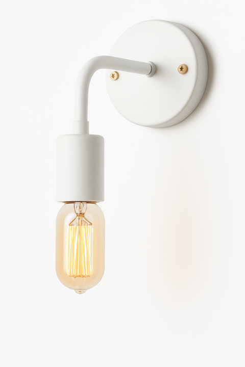 A white wall lamp with a metallic modern curved leg and wall mount with gold accessories and vintage led bulb.
